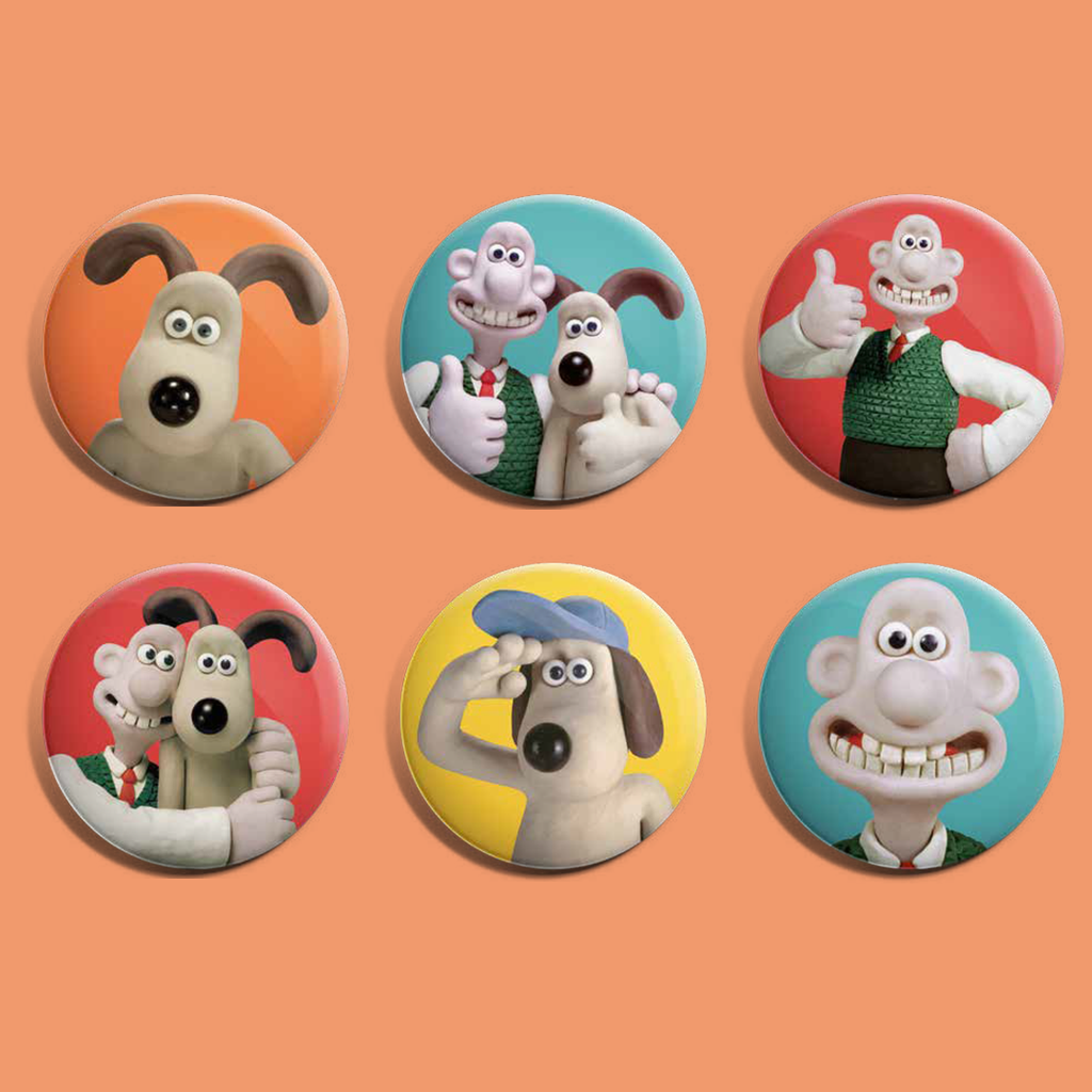 A collection of badges featuring Aardman characters. 1. Gromit on an orange background. 2. Wallace and Gromit thumbs up ona blue background. 3. Wallace thumbs up on a red background. 4. Wallace and Gromit hugging on a red background. 5. Gromit saluting on a yellow background. 6. Close up of Gromit's face. 