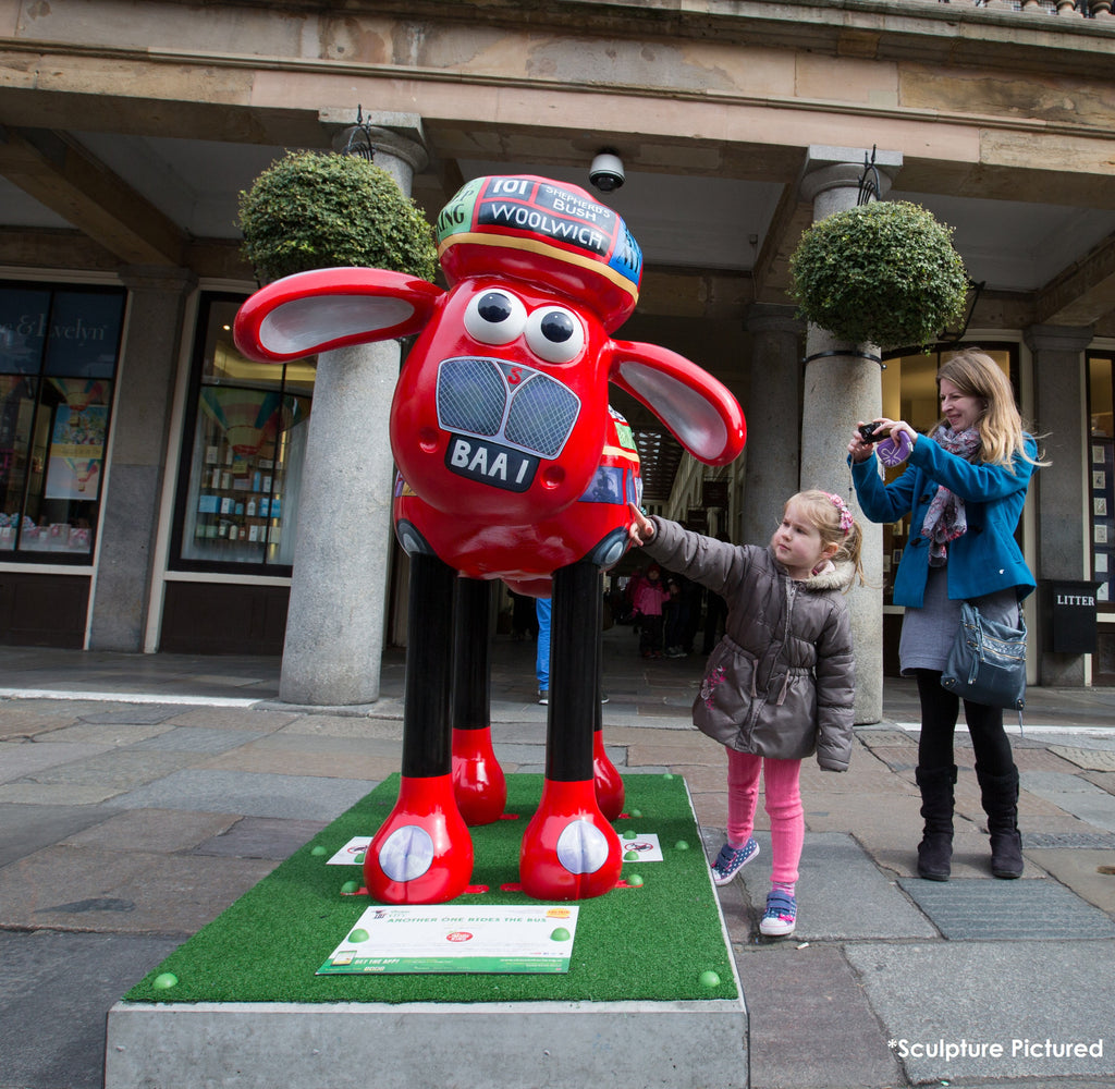 Another One Rides the Bus Shaun the Sheep sculpture with child and mum taking a photo. 