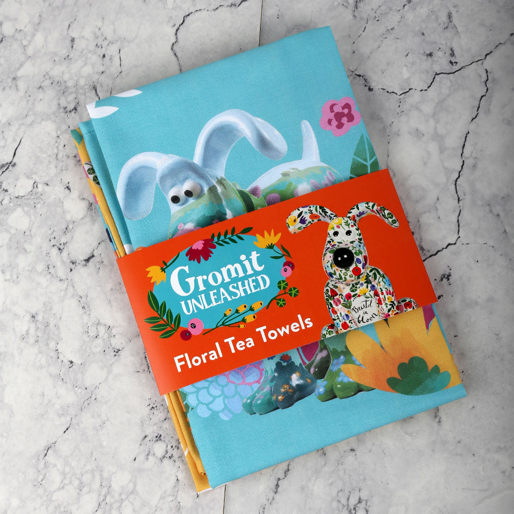 Gromit Unleashed floral tea towel set placed on a marble top. 
