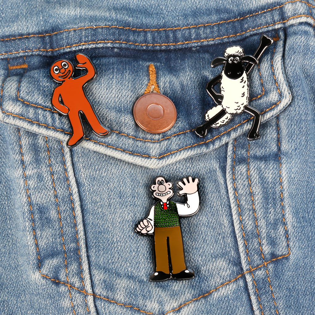 Morph, Shaun and Wallace enamel pin badges on denim pocket