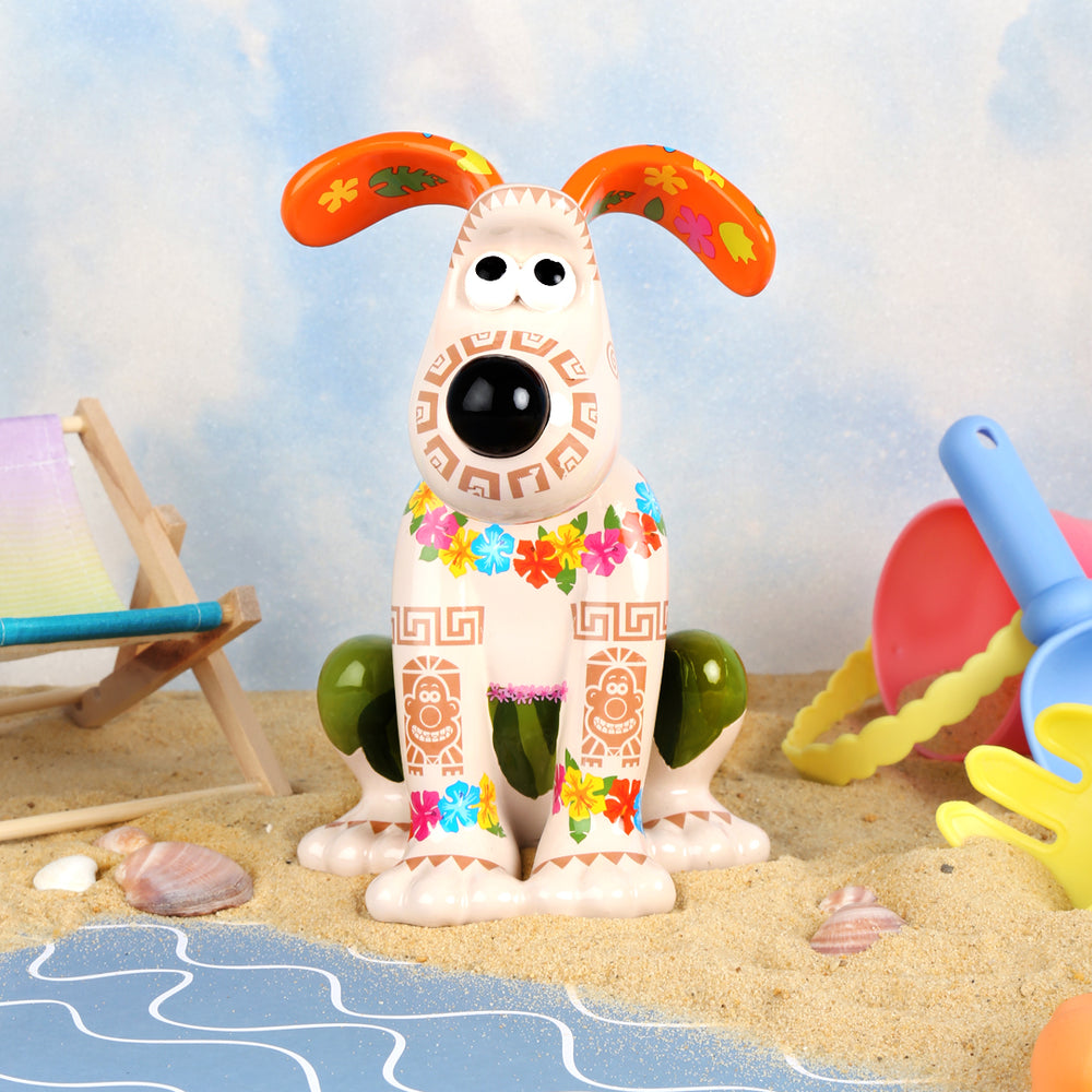 Aloha Gromit figurine from A Grand Adventure, on a UK beach scene. 