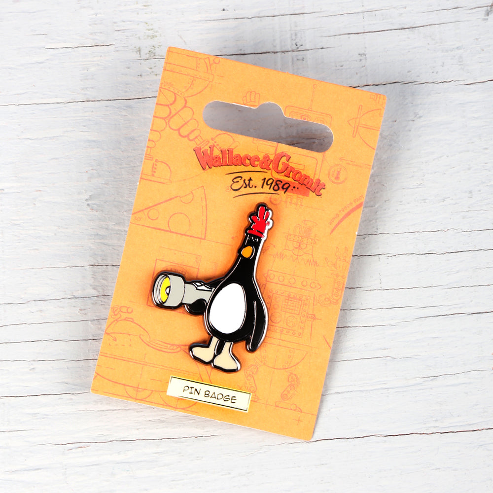 Enamel pin badge of Feathers McGraw holding a torch. 