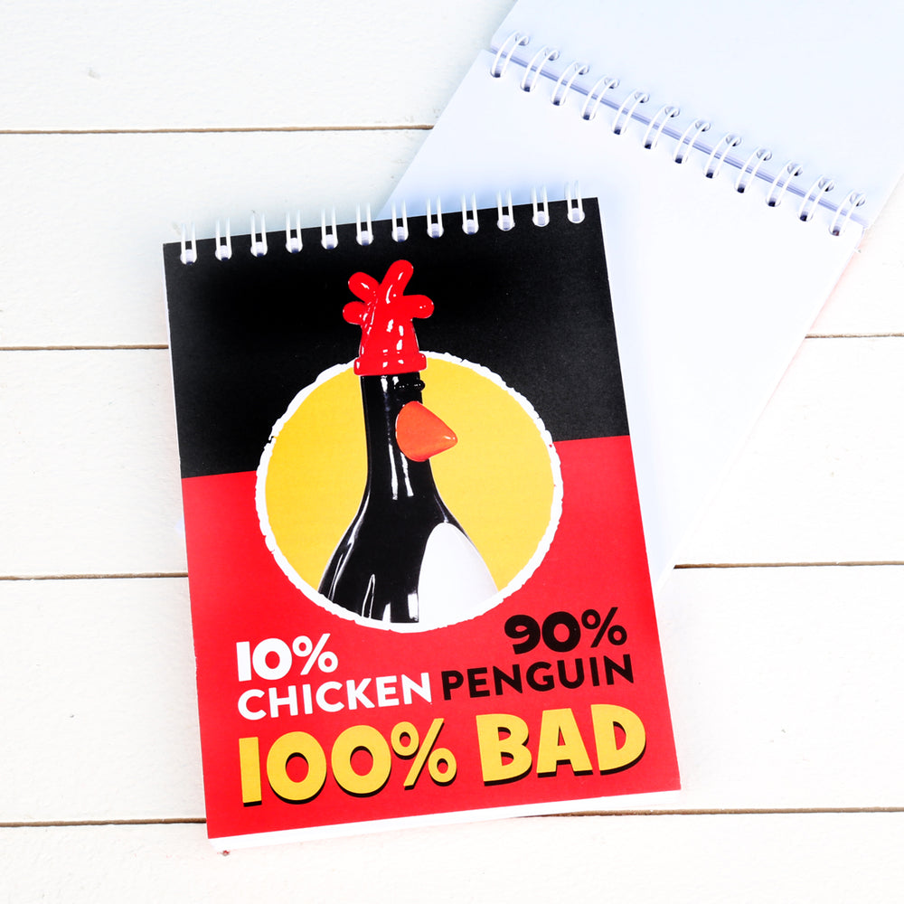 Feathers McGraw figurine plain paged notebook. Black and red with '10% chicken' '90% penguin' '100 bad' 