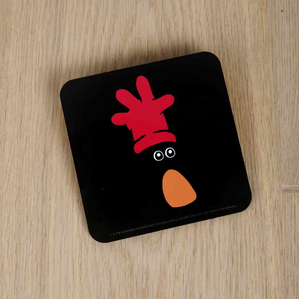 Feathers McGraw all black coaster on a wooden background