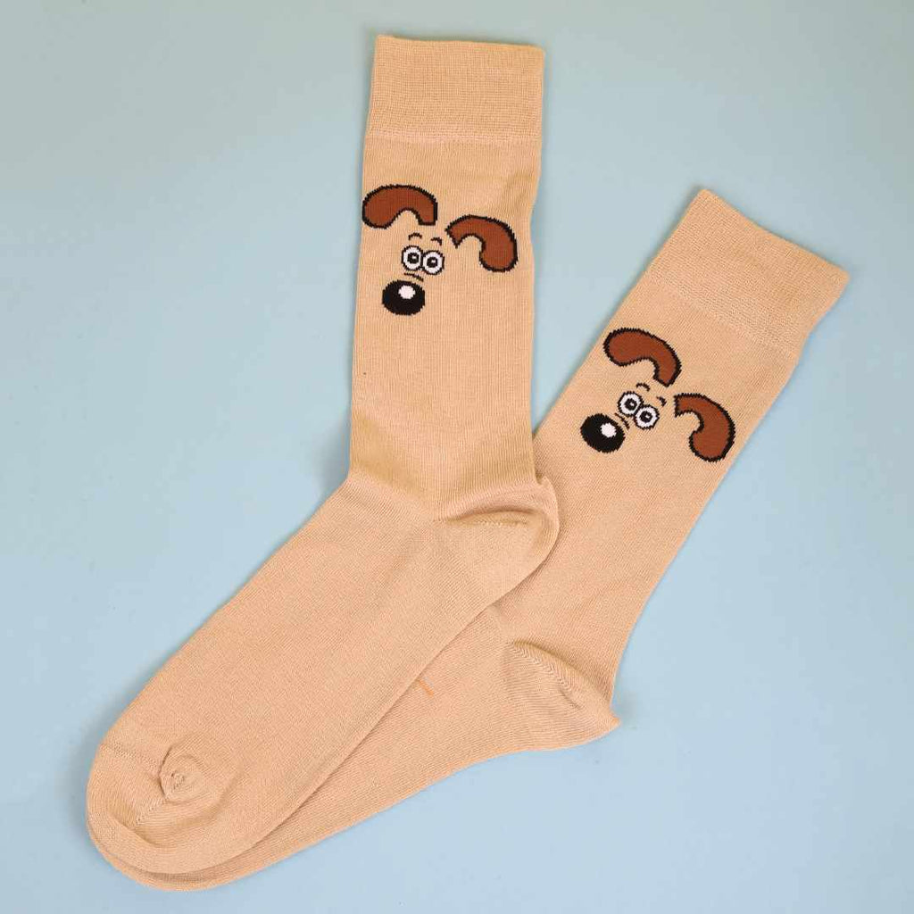 Beige socks with Gromit's face design on a light blue background