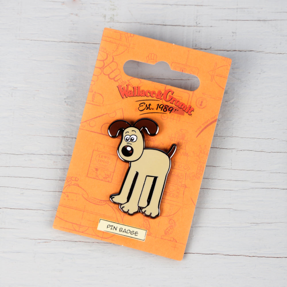 enamel pin badge of Gromit on all fours. 