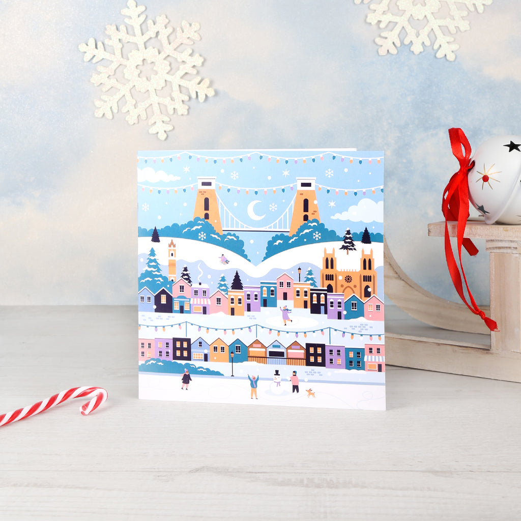  A greetings card featuring a Bristol winter Christmas design with Bristol landmarks in a snowy scene