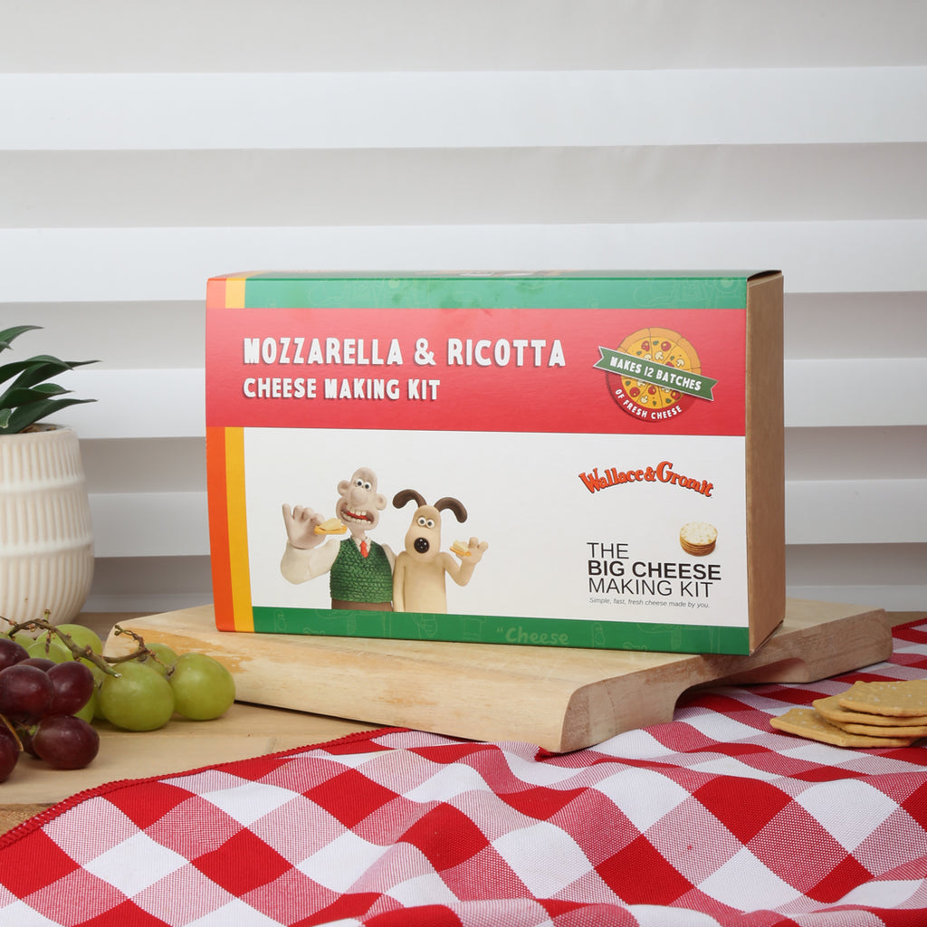 Wallace and Gromit Mozzarella & Ricotta Cheese Making Kit packaging on a table with a checkered tablecloth