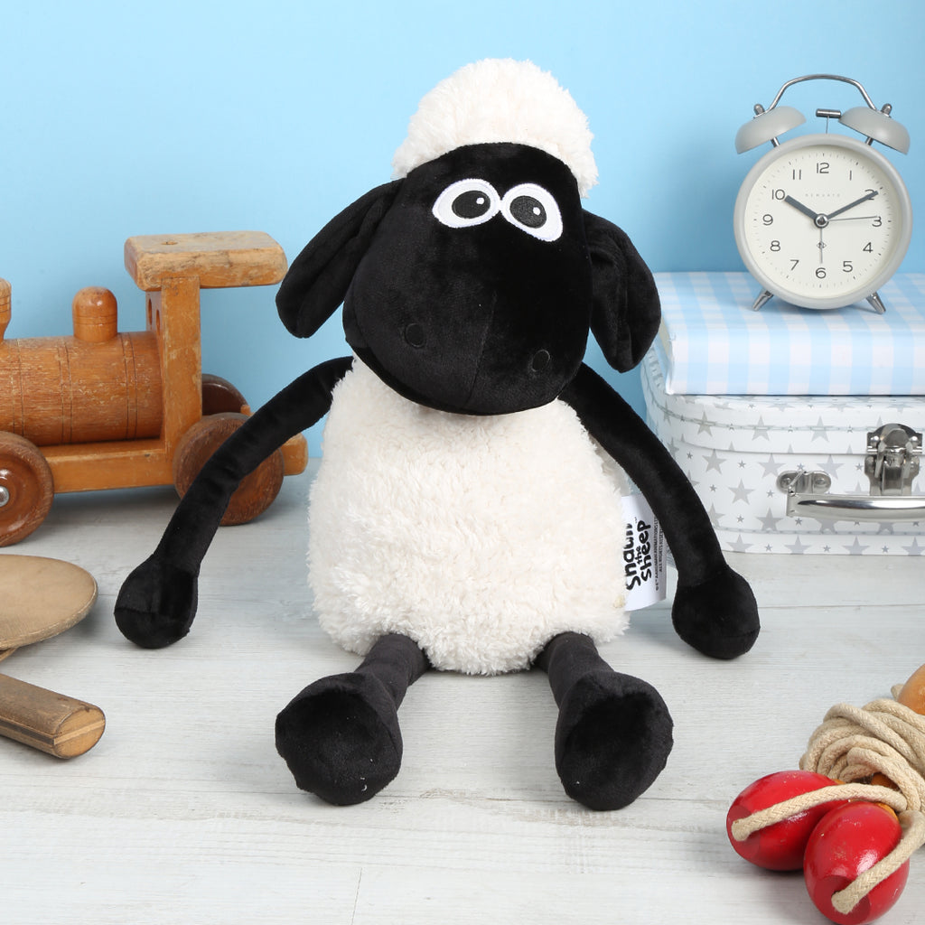 Shaun the Sheep Microwavable Plush Toy with a clock and toys on a light blue background
