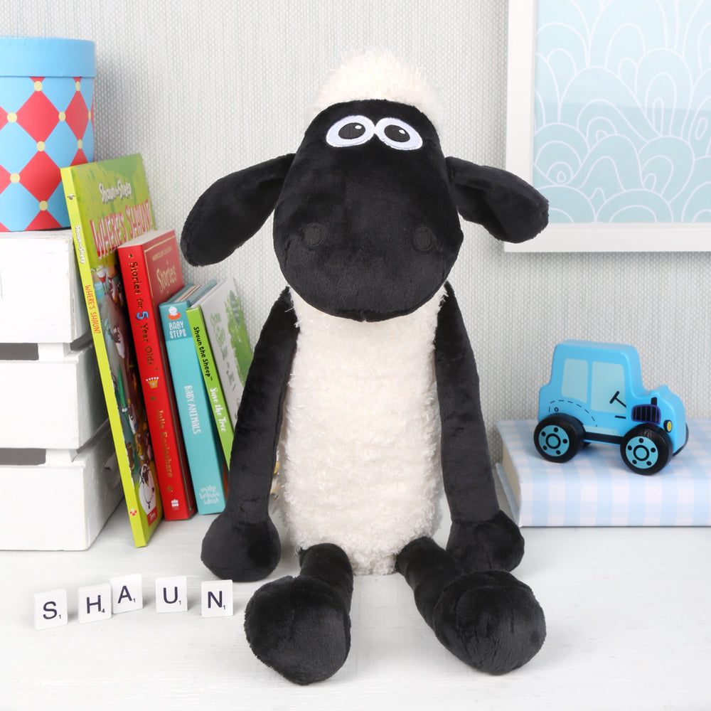 Large shaun the sheep soft toy sat between books and toys