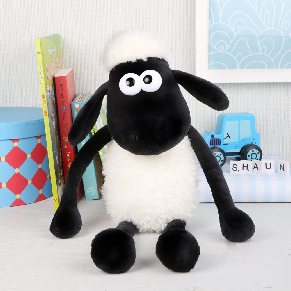 Shaun the sheep soft toy with white fluffy fleece on bedroom shelf between books and toys