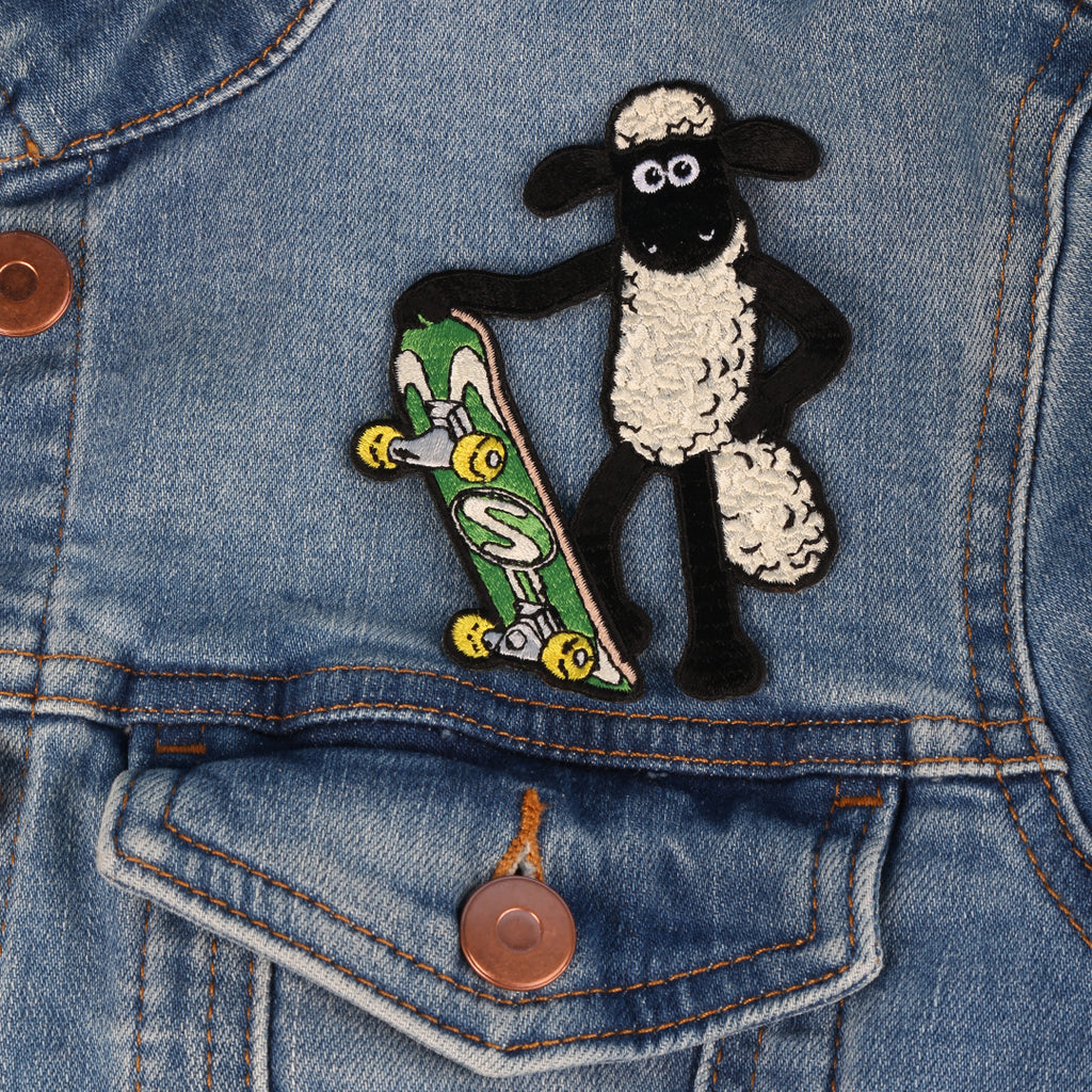 Sew on Shaun the Sheep Badge, Shaun holding a green skateboard. 