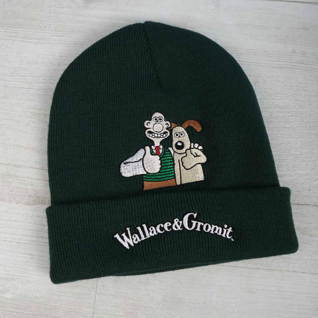 Wallace and Gromit embroidered beanie on a wooden background.