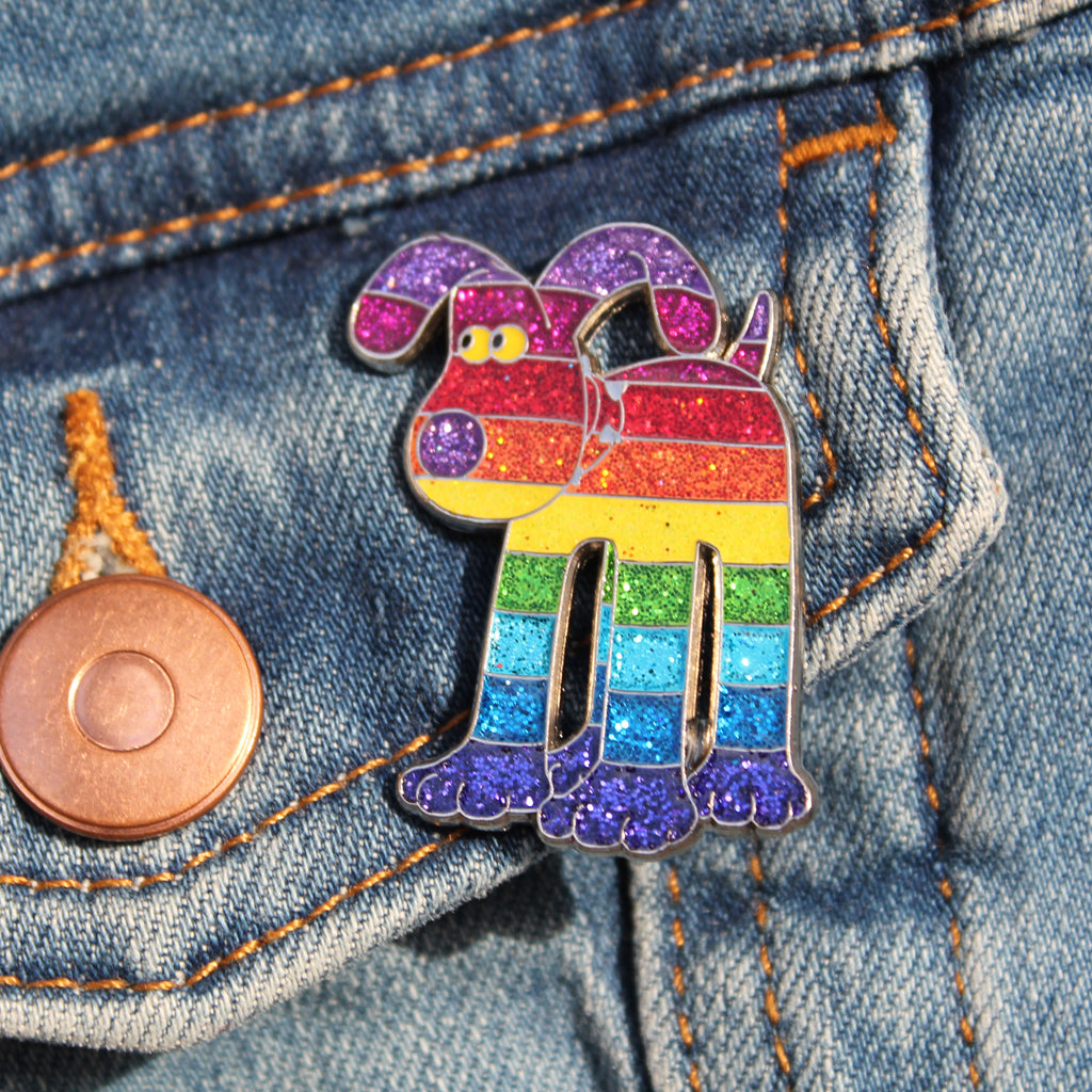 Gromit pin badge featuring rainbow striped design