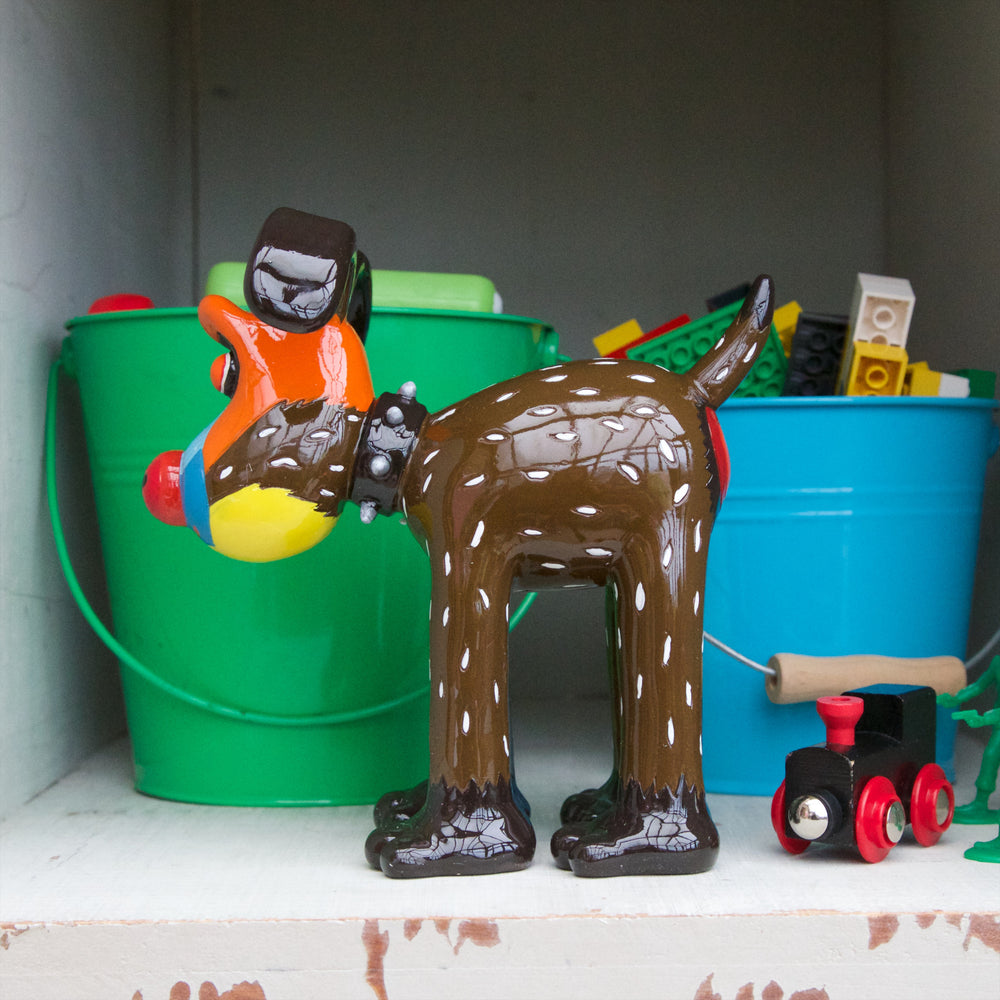A Mandrill's Best Friend Gromit Figurine stood in front of blue and green buckets full of lego pieces. 