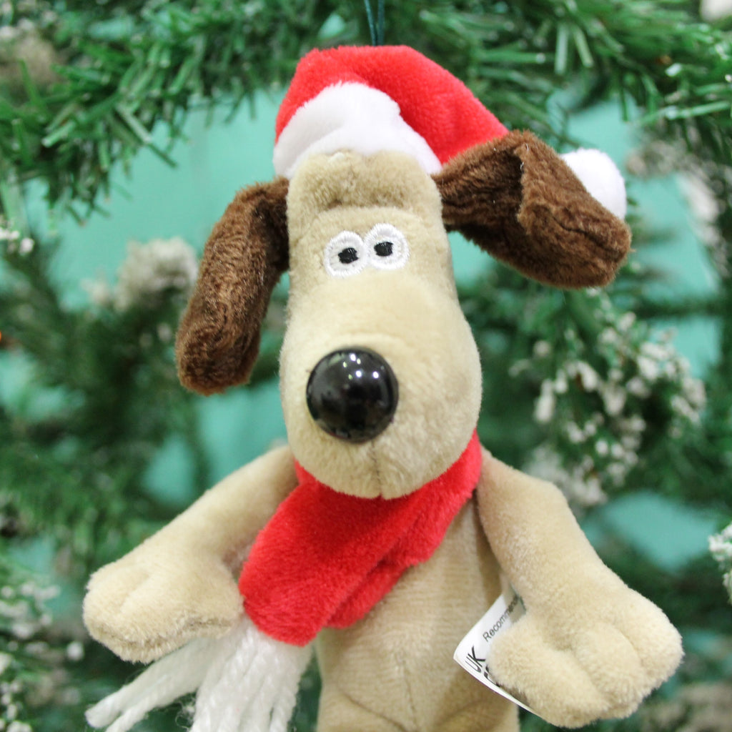 close up of soft toy gromit with red hat and santa scarf