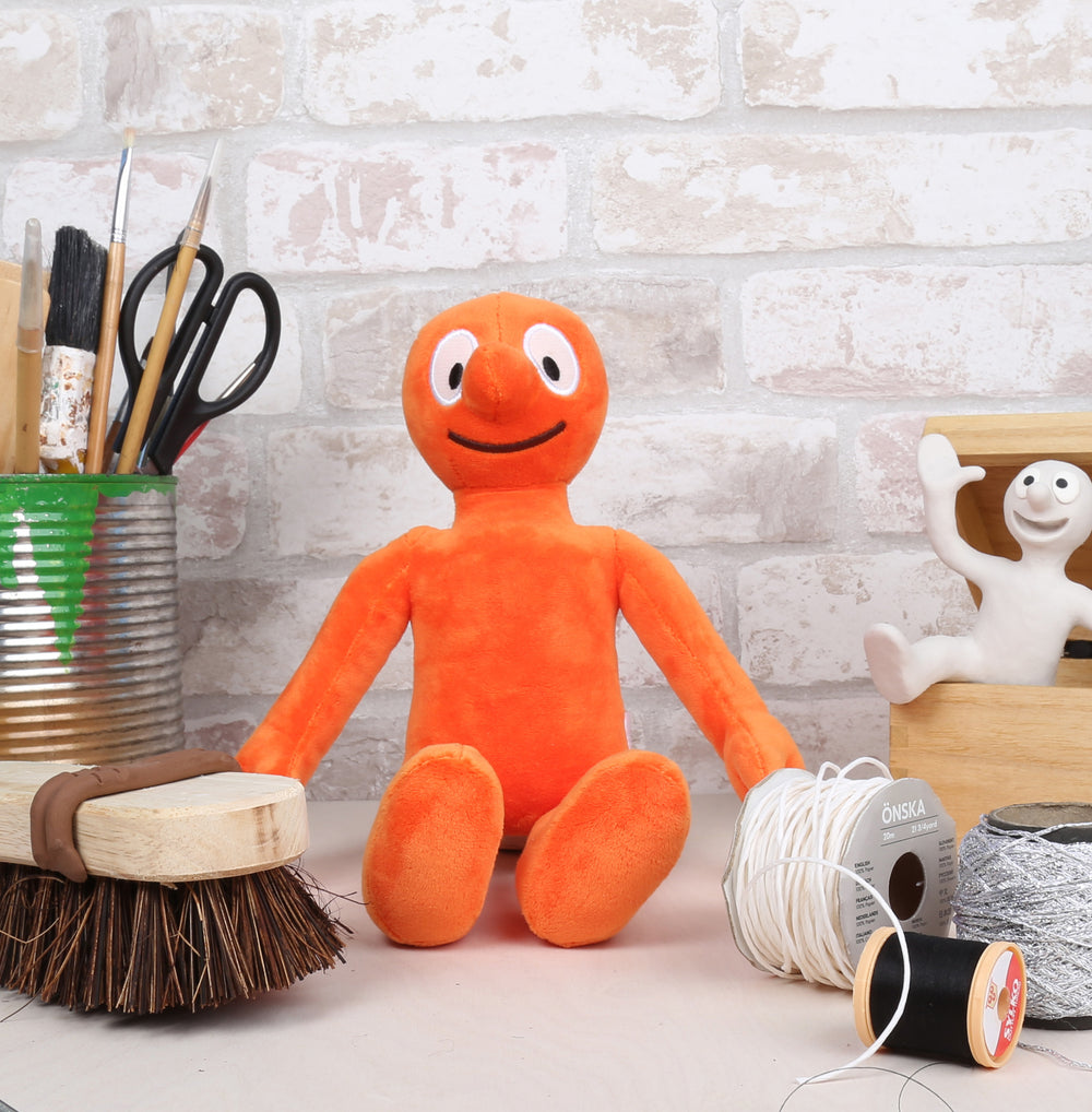 Morph soft toy sitting within classic Morph scene including Chas