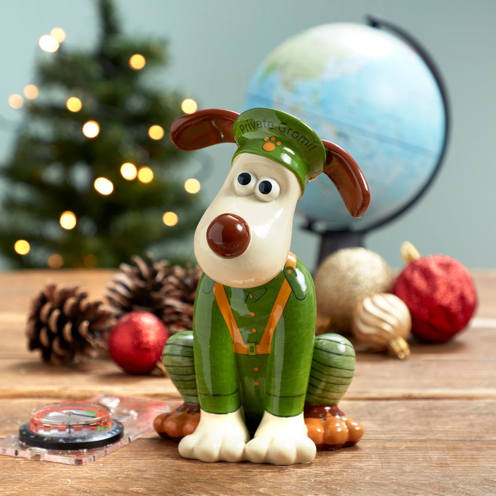Bristol's Own 'Privare Gromit' Figurine. Sat next to a compass, globe and Christmas decorations. 